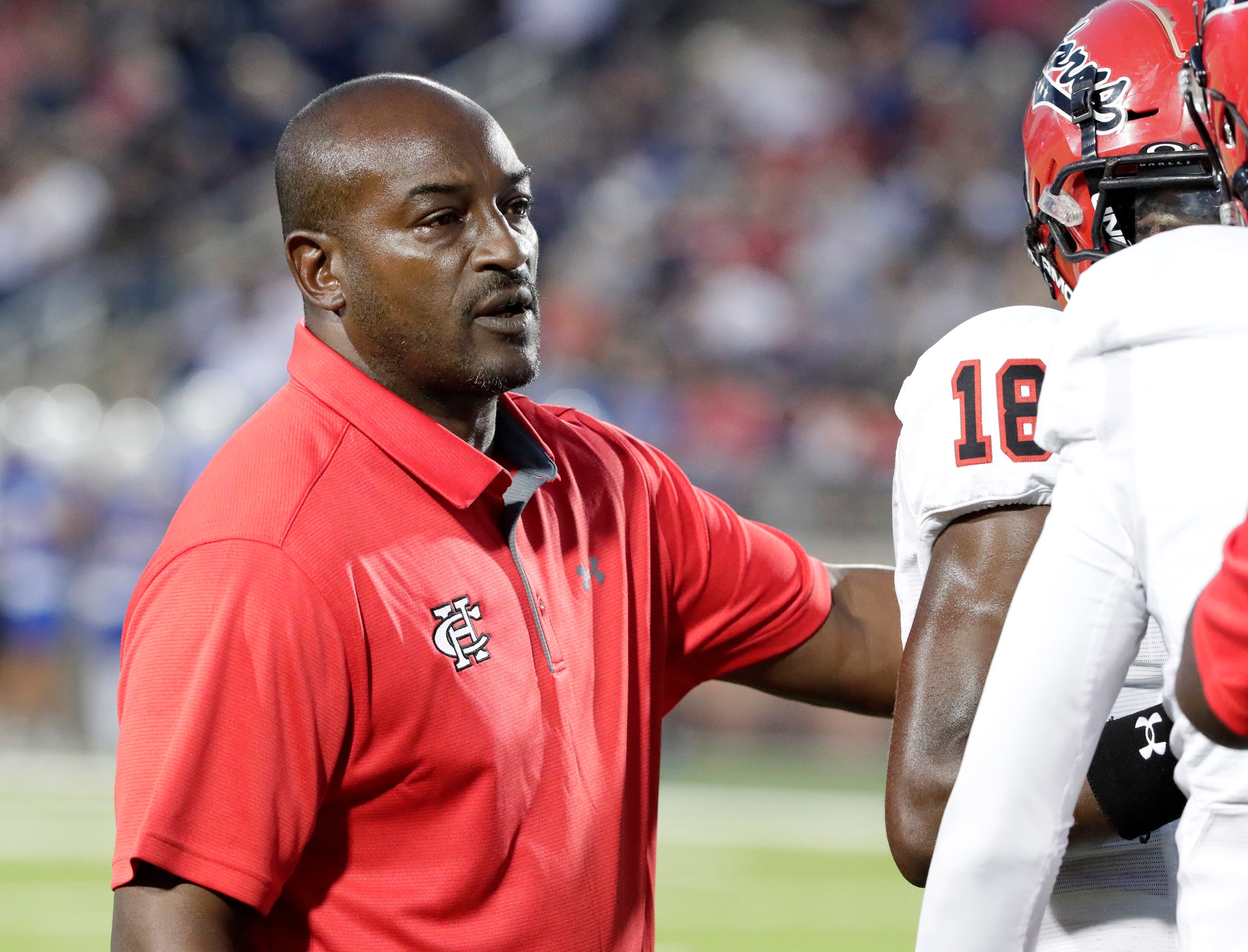 Cedar Hill High School head coach Nick Ward talks to his players during a time out in the...