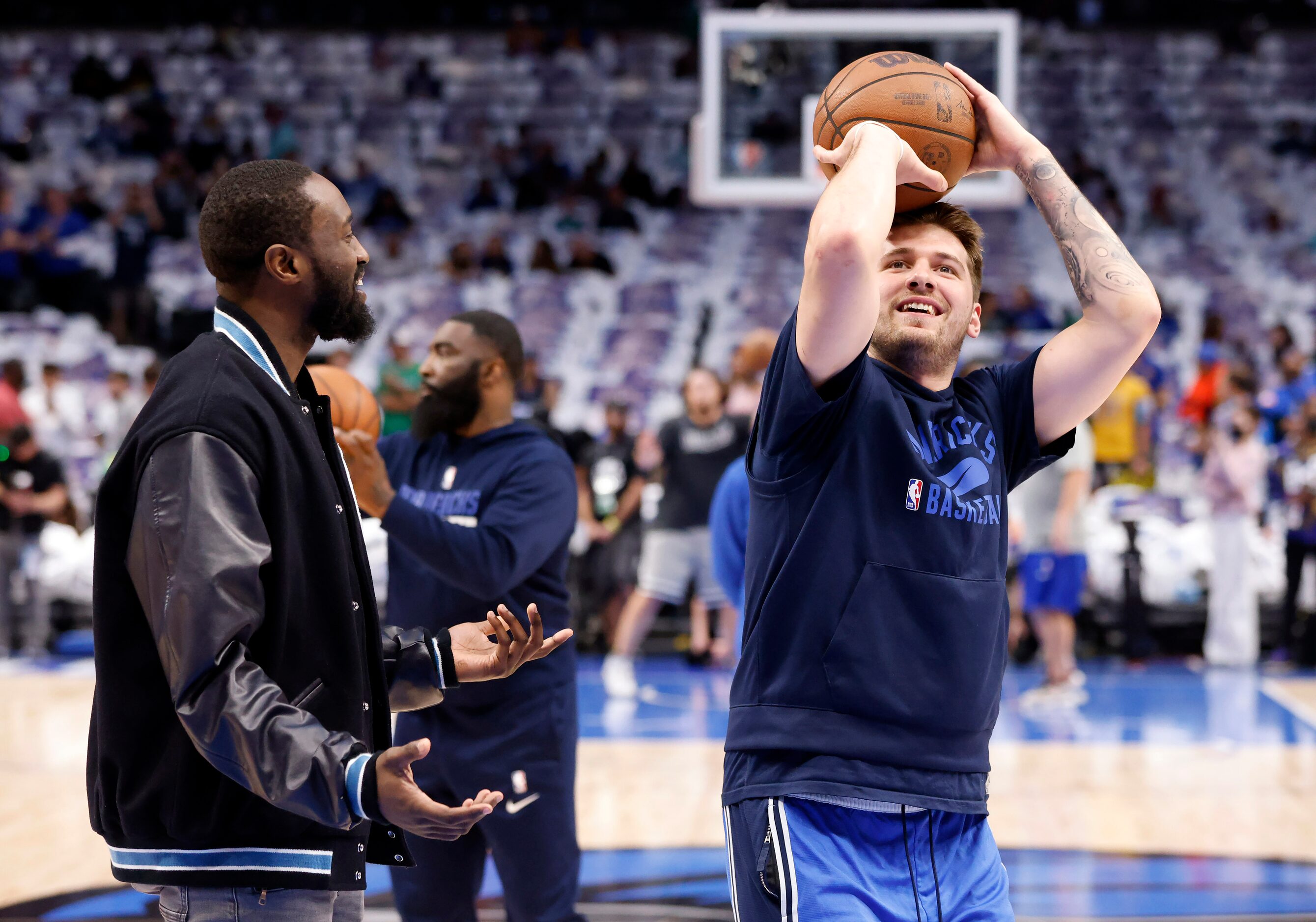 Dallas Mavericks guard Theo Pinson (left) tries to distract a free throw by teammate Luka...