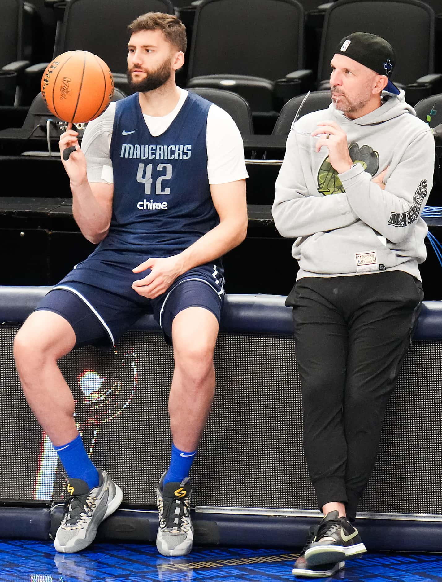 Dallas Mavericks forward Maxi Kleber (42) spins a basketball on his finger as he sits with...