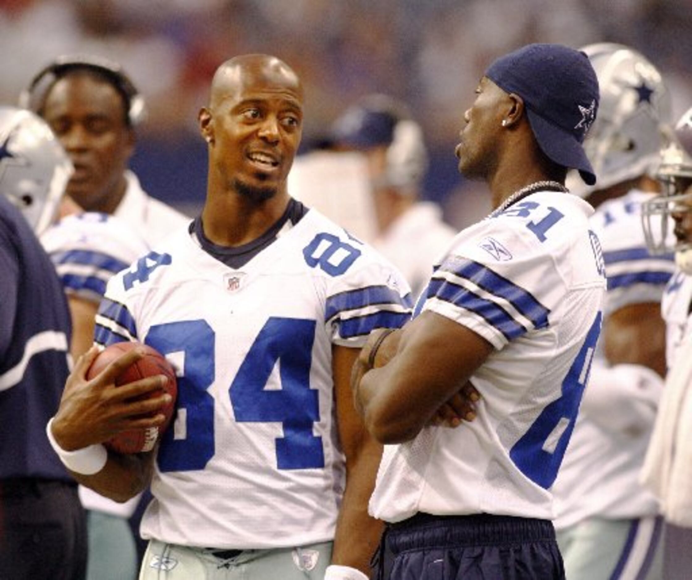 Dallas Cowboys wide receiver Terry Glenn covers up the ball after