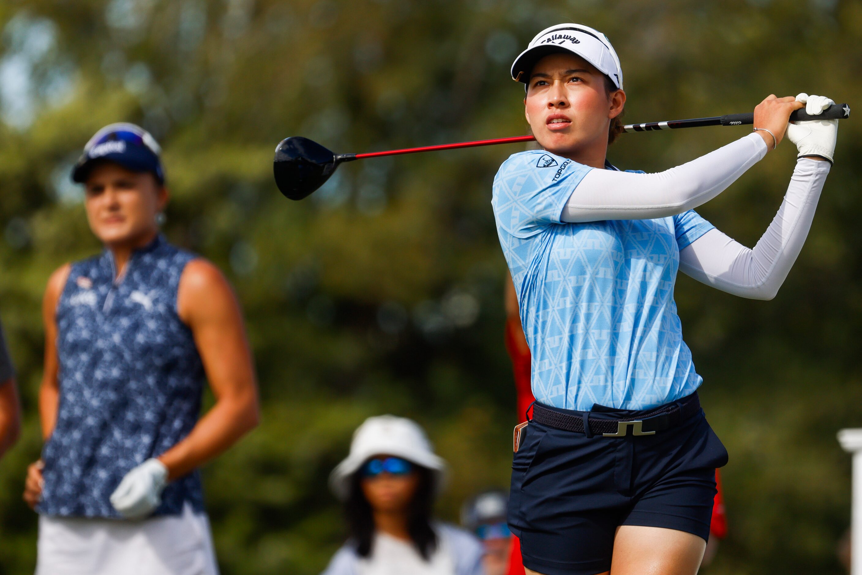 Atthaya Thitikul of Thailand tees off on the ninth hole past Lexi Thompson of the United...