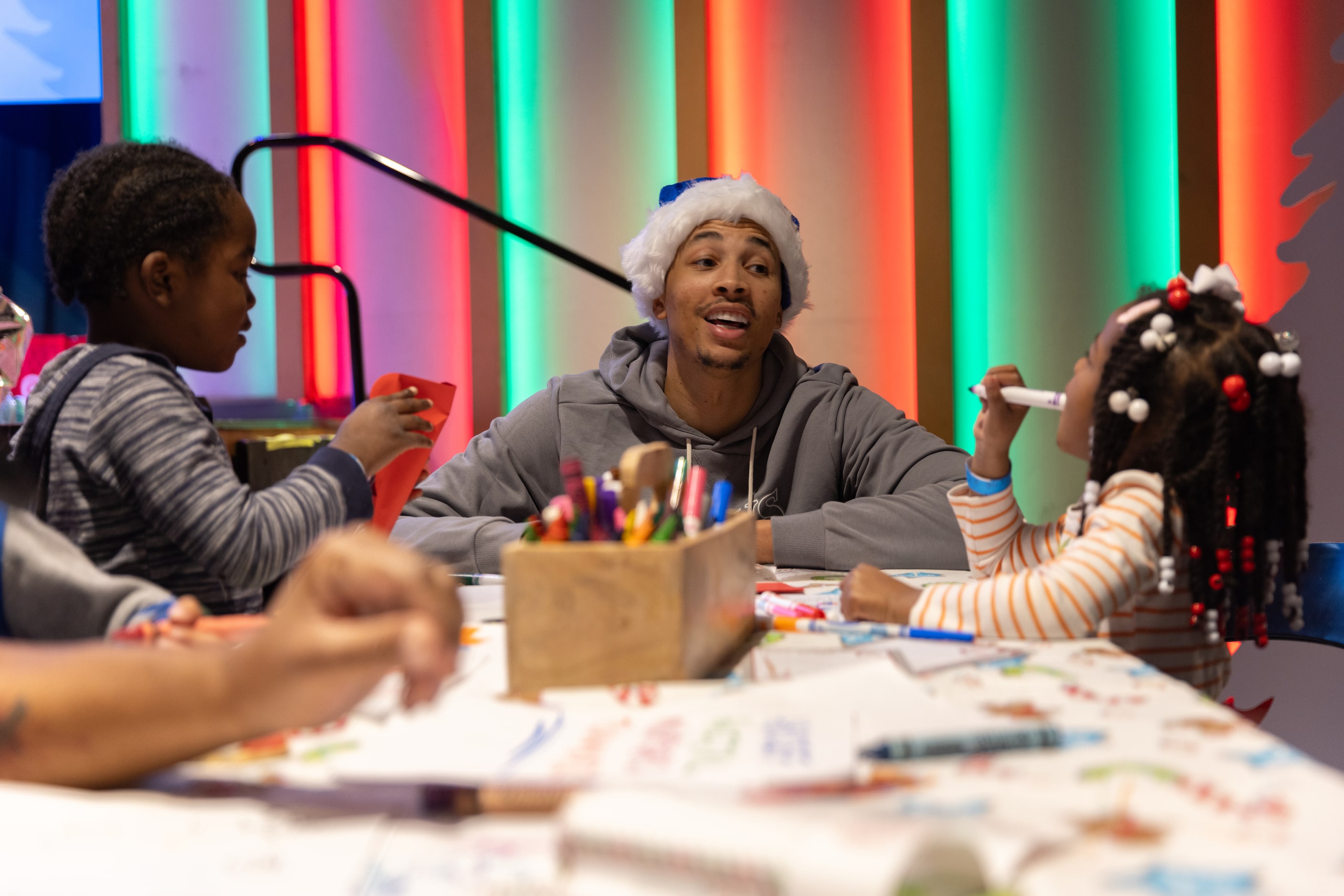 Mavericks guard Dante Exum draws with kids during the Cookies With Santa event in Dallas on...