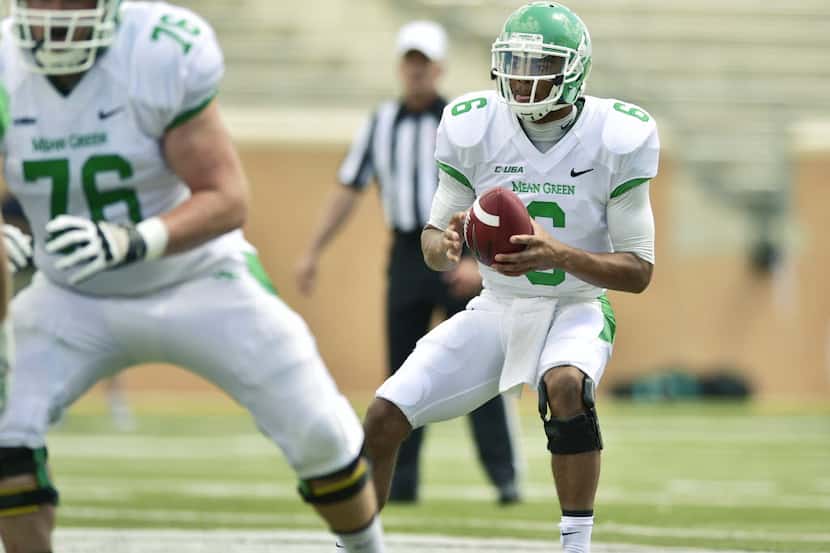 Former North Texas quarterback Dajon Williams drops back to pass in the Green-White spring...