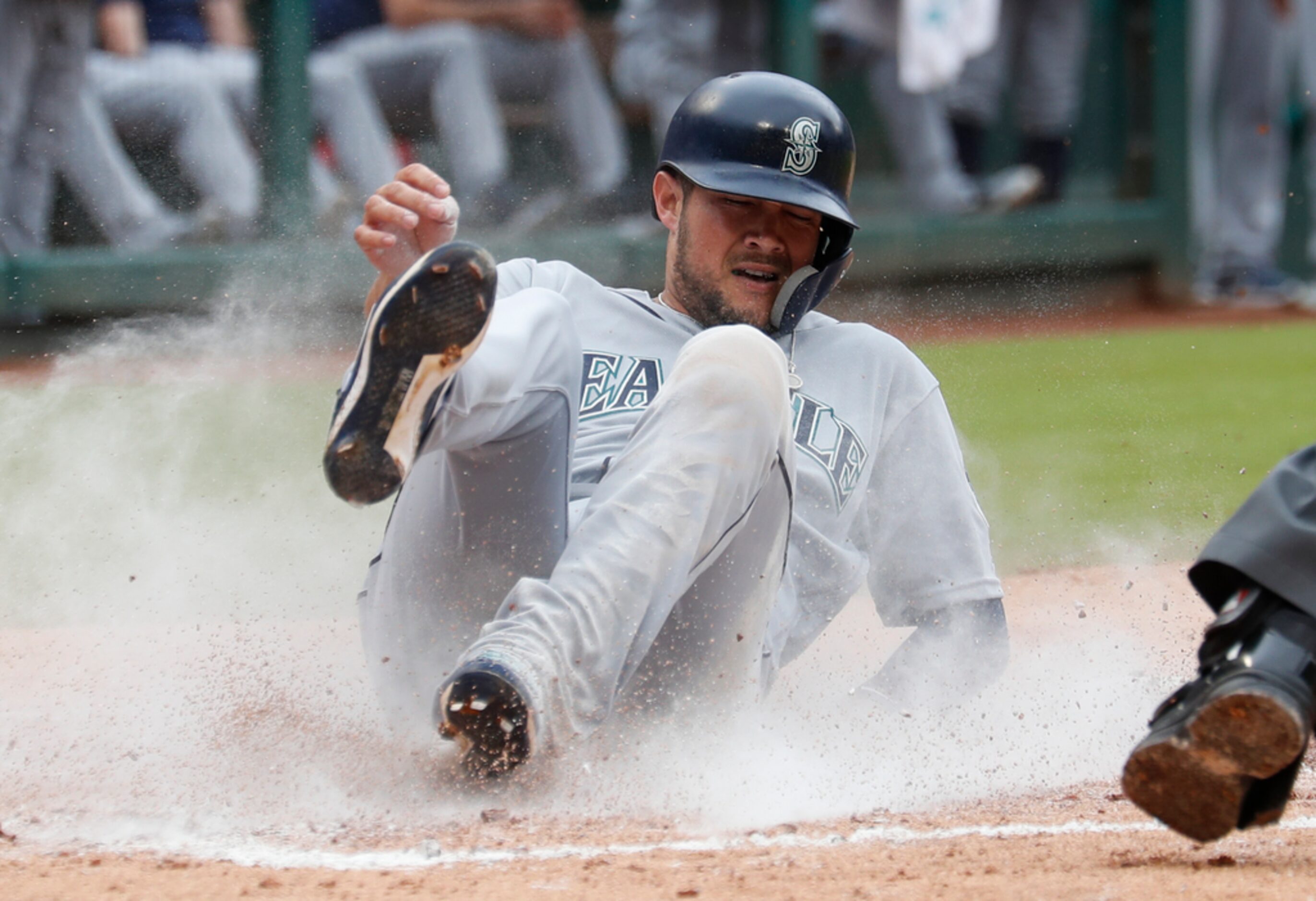 Seattle Mariners' Kristopher Negron slides to score on a triple by Guillermo Heredia during...