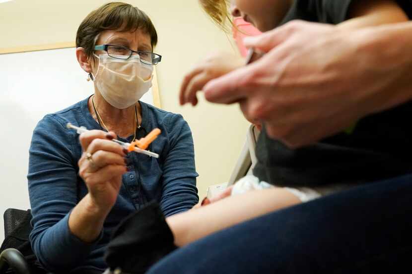 Deborah Sampson, left, a nurse at a University of Washington Medical Center clinic in...