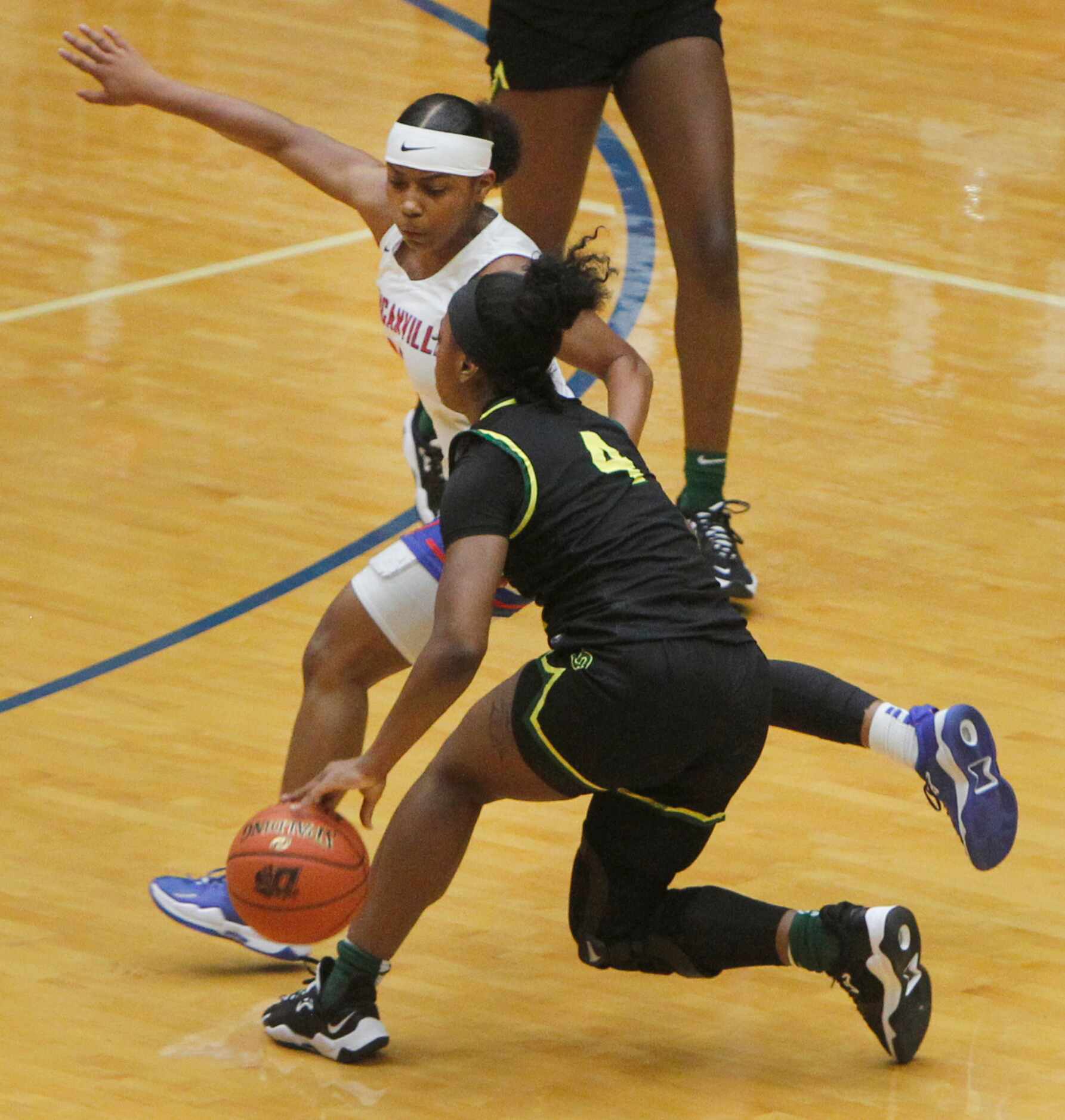 DeSoto's Ja'Mia Harris (4) brings the ball down as she is defended by Duncanville's Tristen...