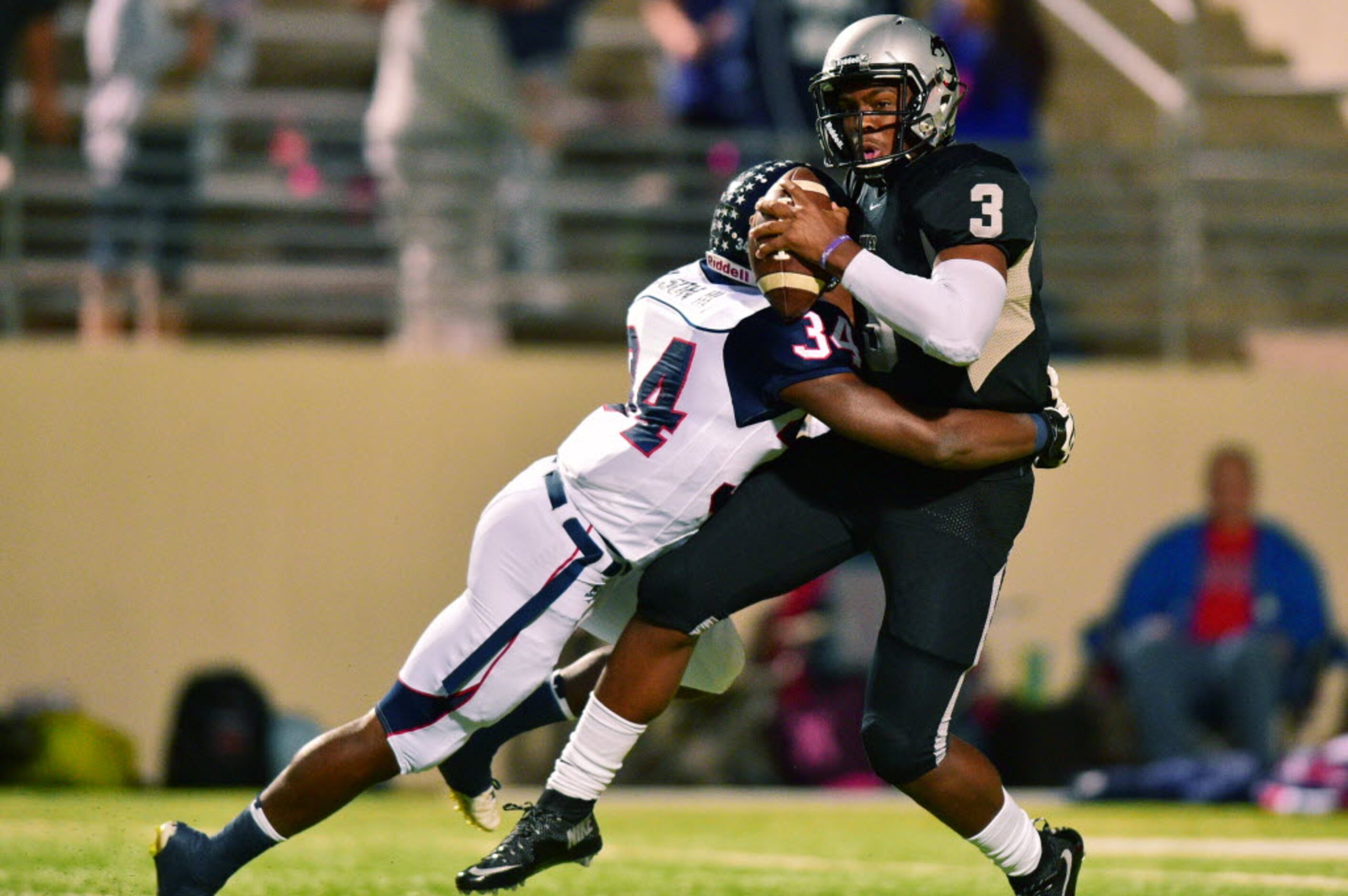 Guyer junior quarterback Shawn Robinson (3) is sacked by Ryan junior defensive end Thomas...