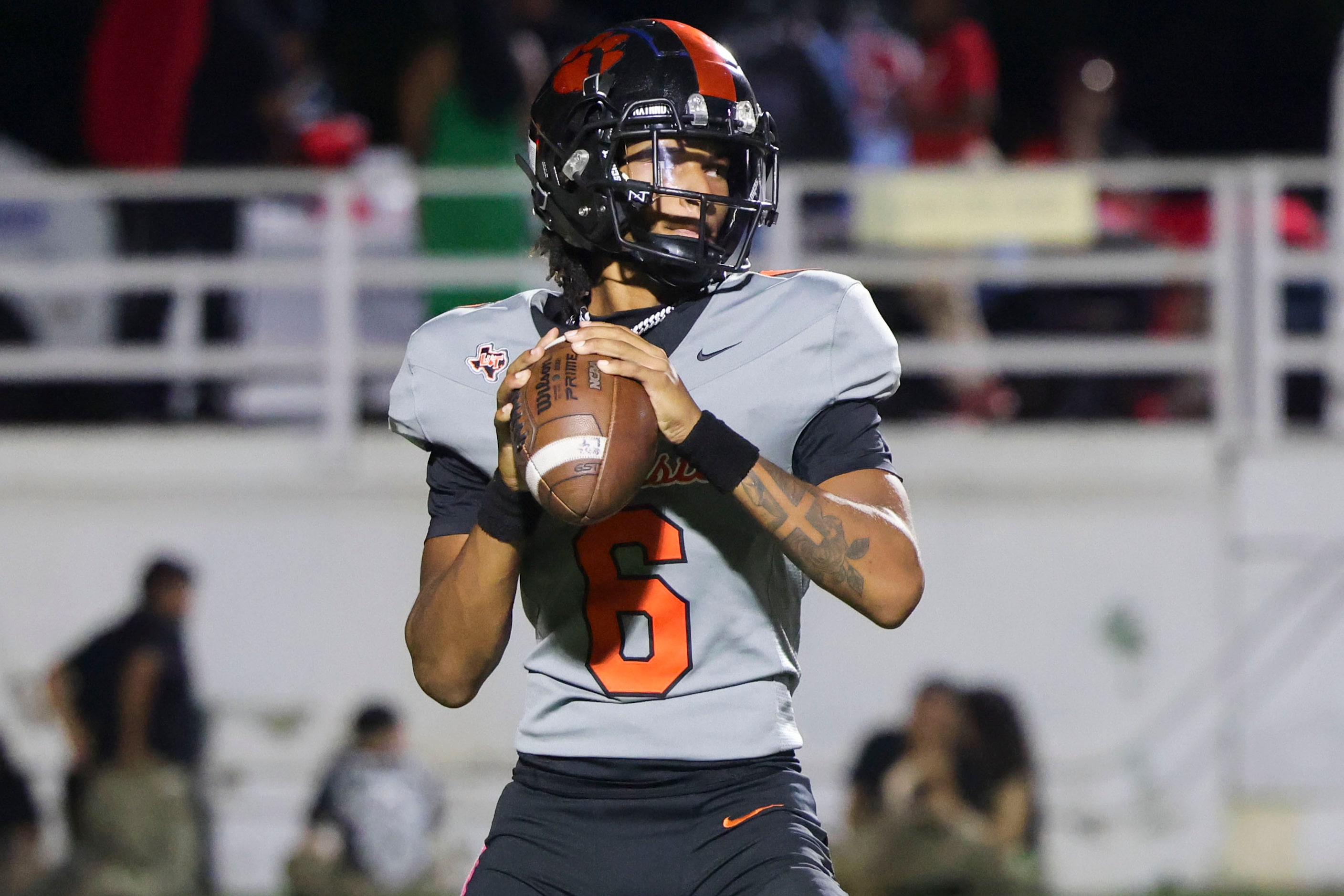 Lancaster High’s QB Carter Jones looks to throws a pass  during the second half of a...