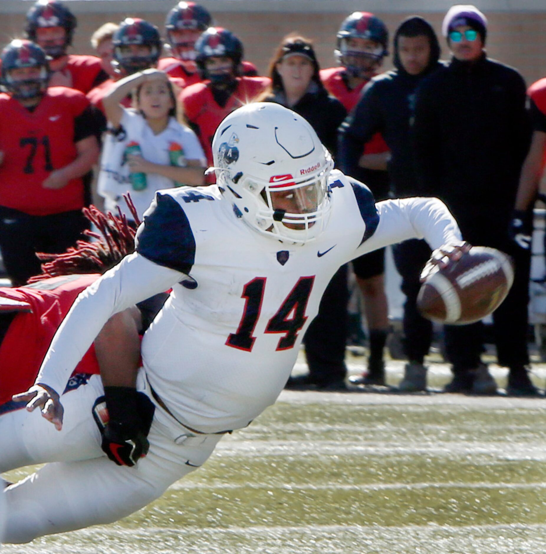 Allen quarterback Grant Tisdale (14) shows great focus and athleticism as he finds a way to...