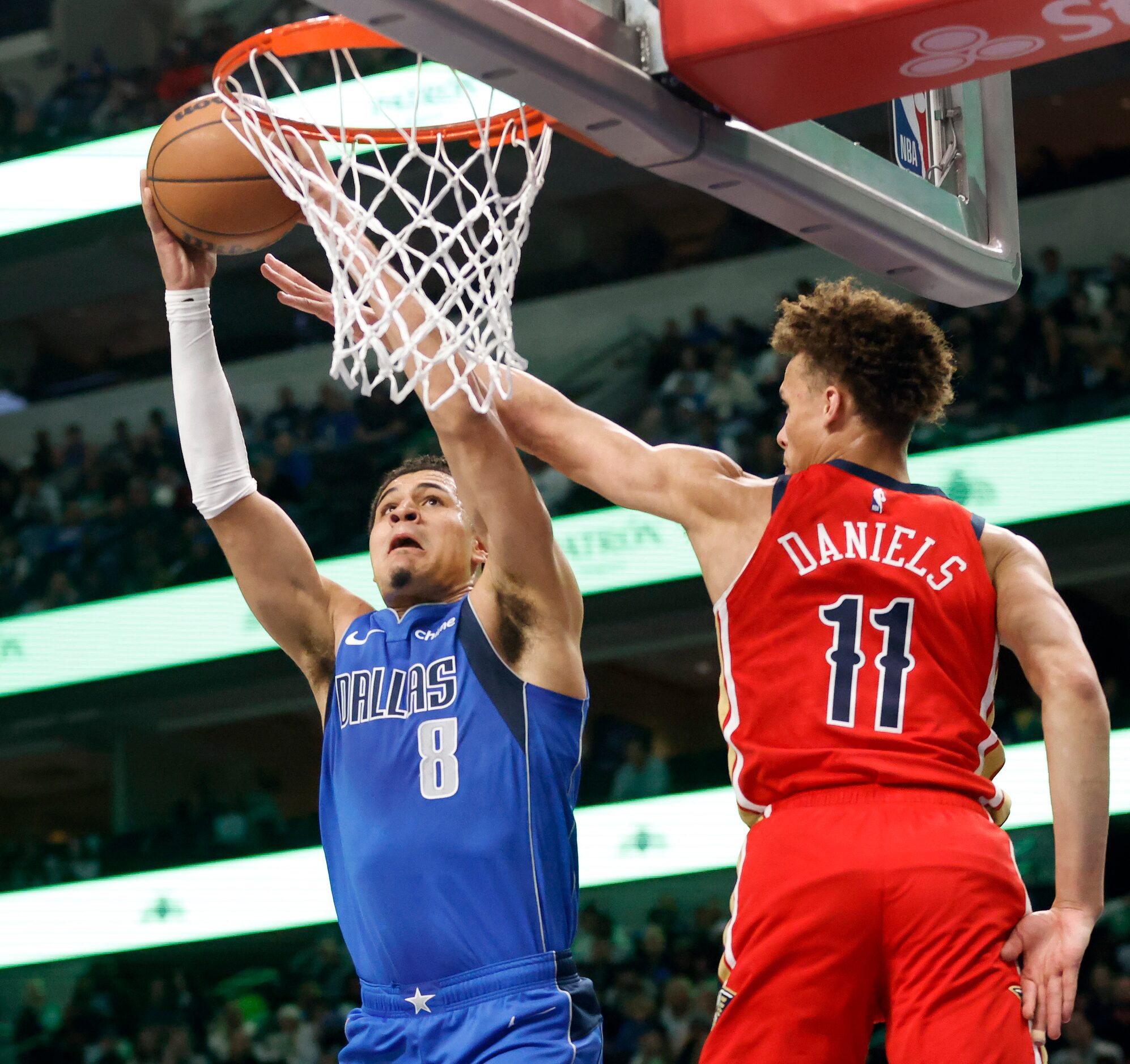 Dallas Mavericks guard Josh Green (8) scores over New Orleans Pelicans guard Dyson Daniels...