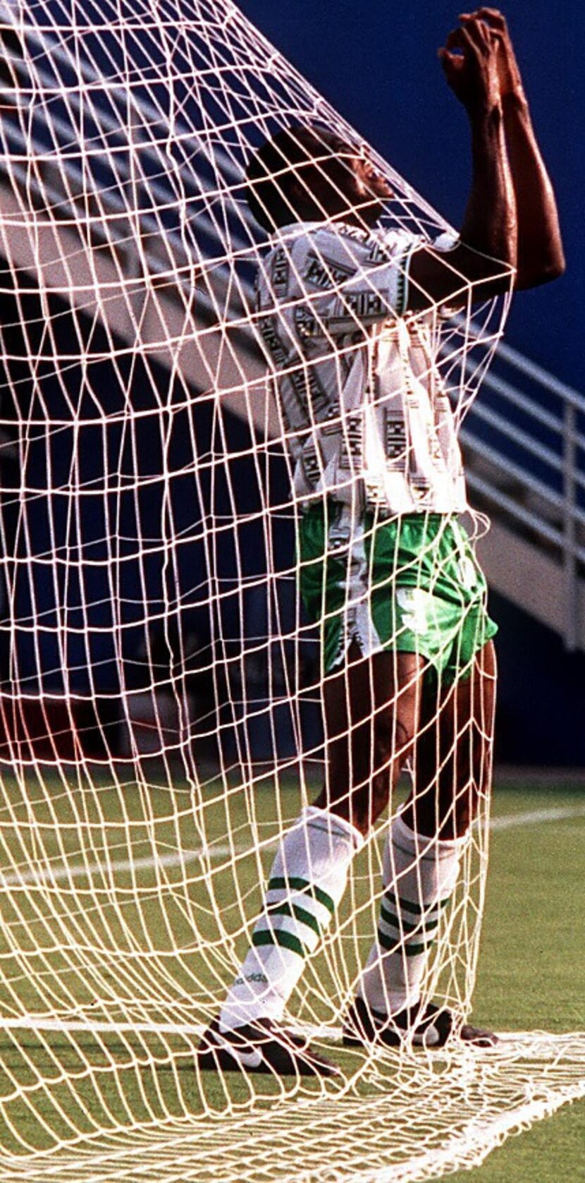 6/21/94 -- Nigeria's forward Rashidi Yekini celebrates in the net after scoring Nigeria's...