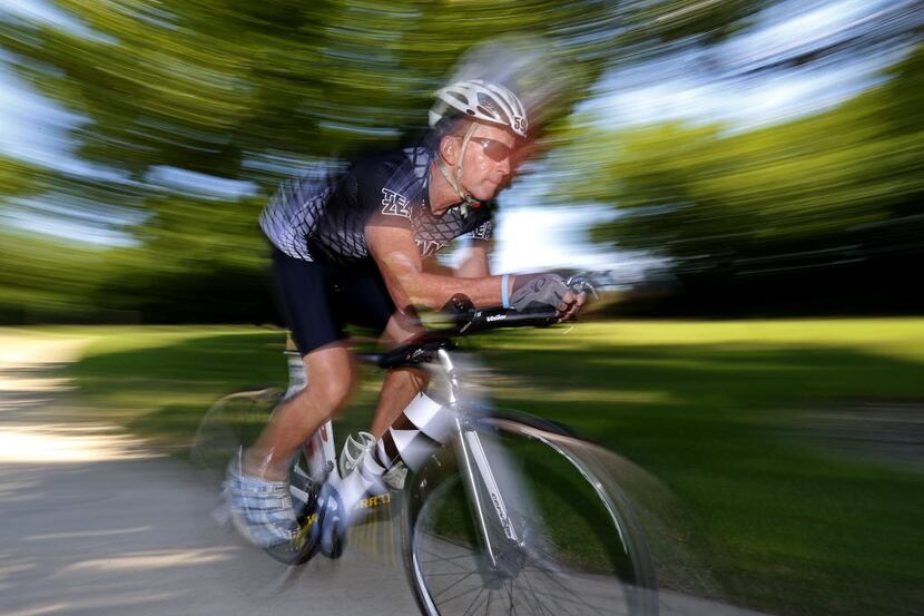 Tom Hulsey, an Ironman competitor and prostate cancer survivor, rides his bike on Wednesday,...