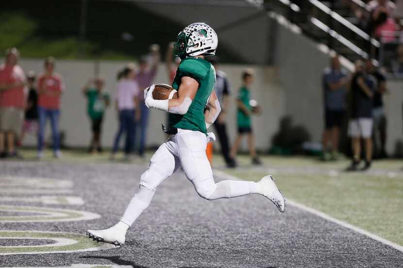 Southlake Carroll senior running back T.J. McDaniel (4) scores a touchdown during the first...