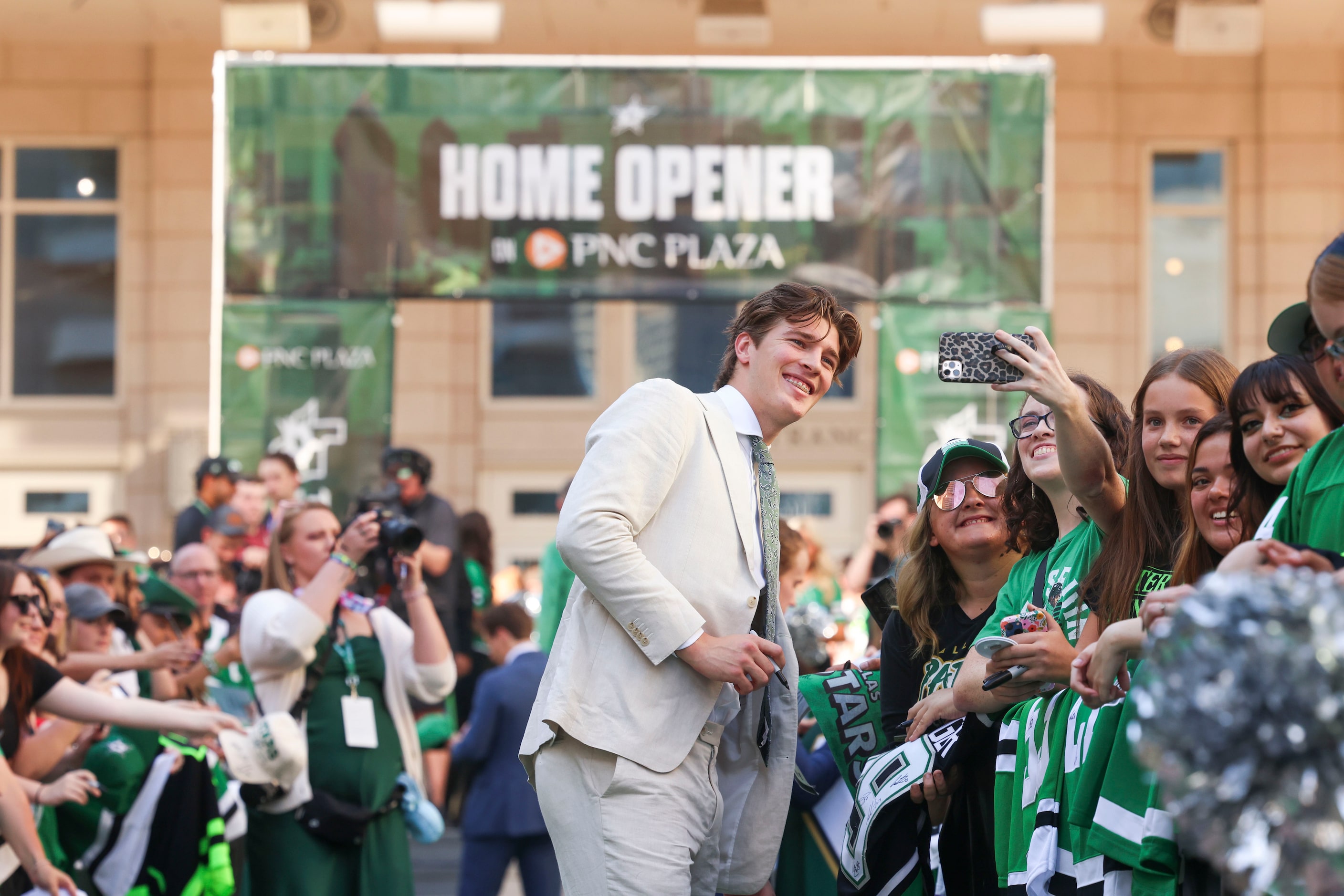 Dallas Stars center Oskar Bäck takes photos with fans as he makes his way during the team’s...