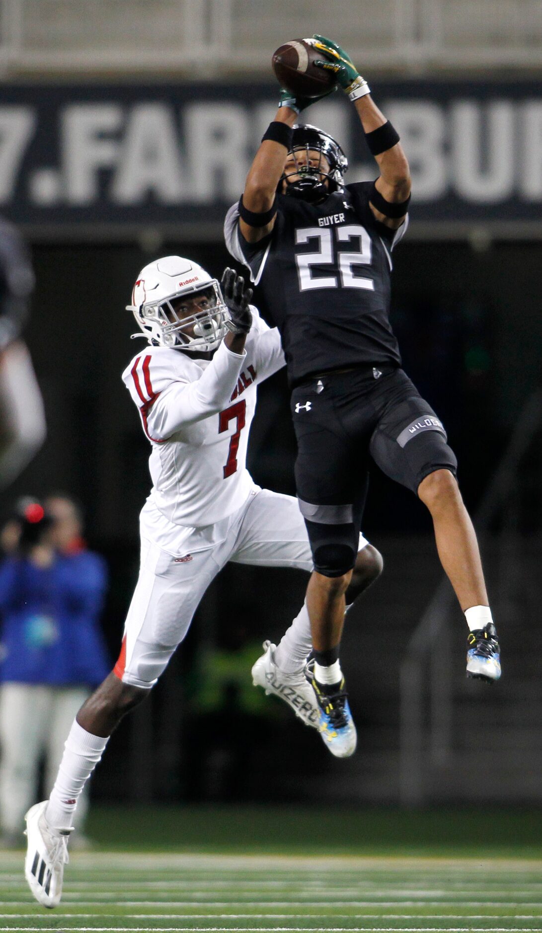 Denton Guyer defensive back Peyton Bowen (22) leaps to intercept a pass intended for Tomball...