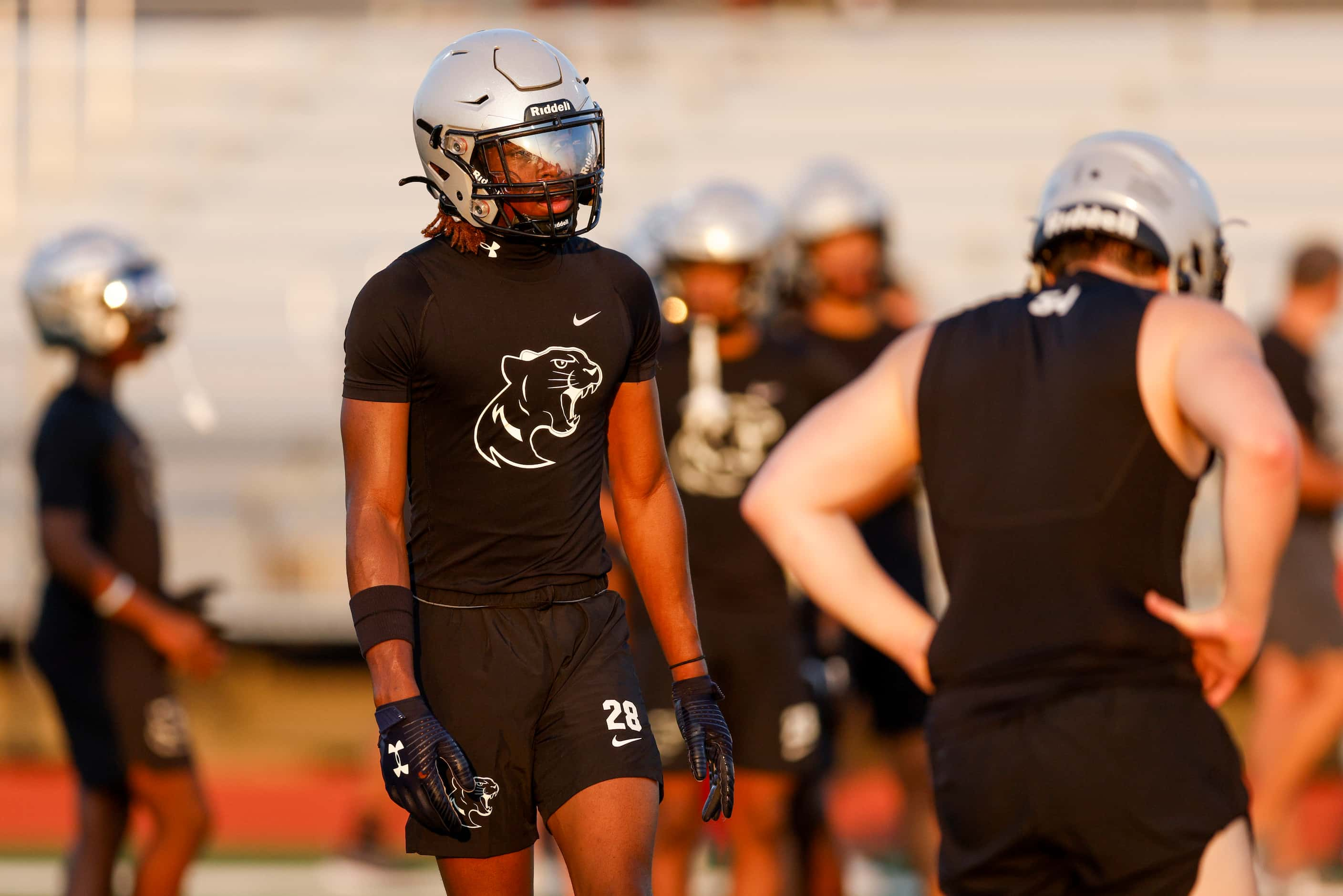 Running back Sentel Simpson walks on the field during an early morning football practice at...