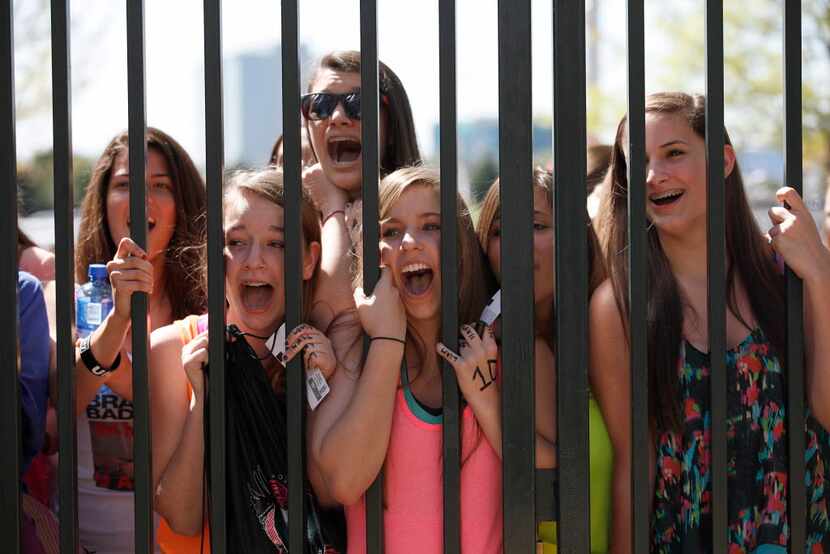 Screaming teenage fans of One Direction at Dr Pepper Ballpark on March 24, 2012. 