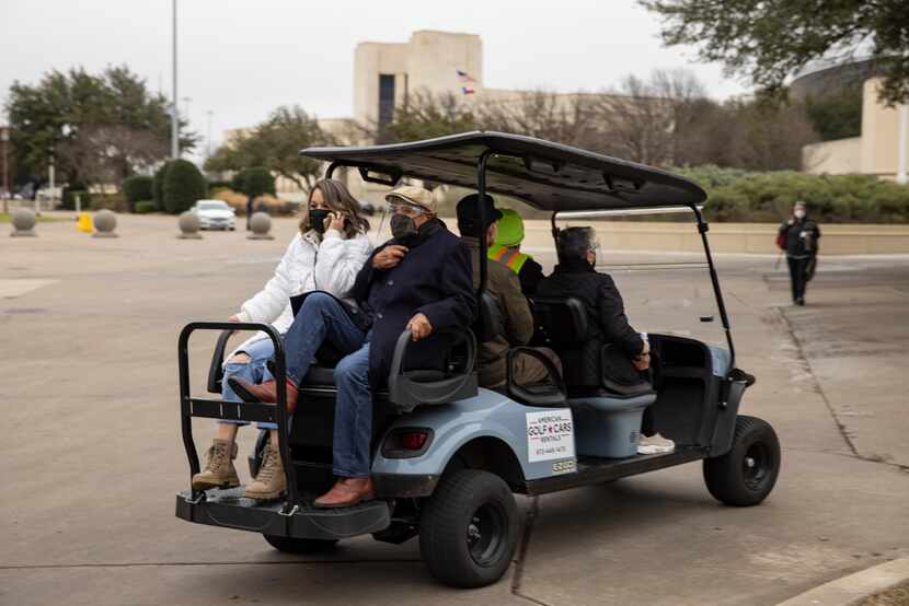 A cart takes people to get vaccines at Fair Park in Dallas on Tuesday, Feb. 9, 2021. (Juan...