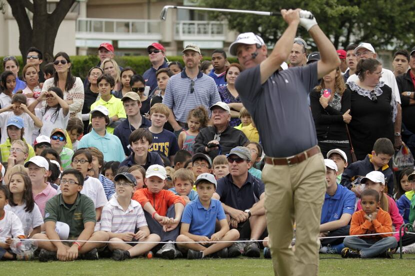 The gallery watches Pro Golfer Harrison Frazar demonstrate a shot at the Byron Nelson youth...