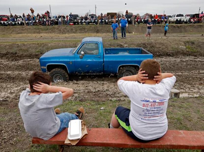 
Wylie residents Kadon Couch (left), 8, and Jacob Swartz, 7, cover their ears at the sound...