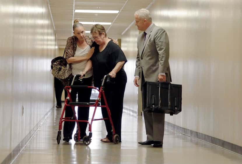  Joseph Hutcheson’s wife,  Nicole Hutcheson, consoles his mother, Ruth Boatner, as they are...