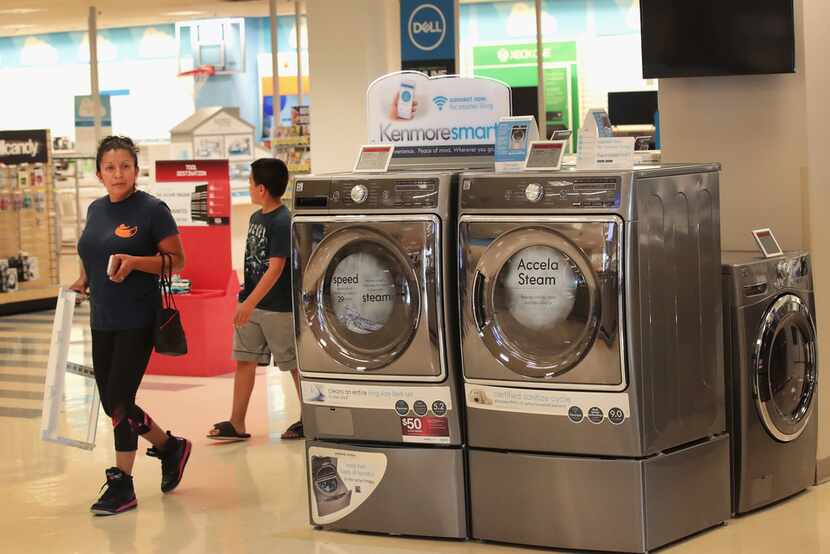 Shoppers walk by a Kenmore appliances display at a Sears retail store in 2017 in Schaumburg,...