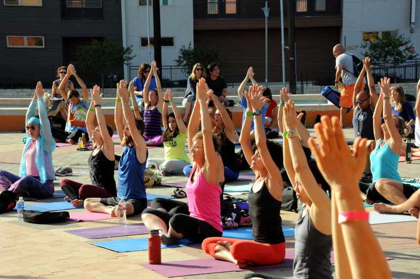 The session starts with the easy pose at the D-FW Free Day of Yoga Kickoff at the Latino...