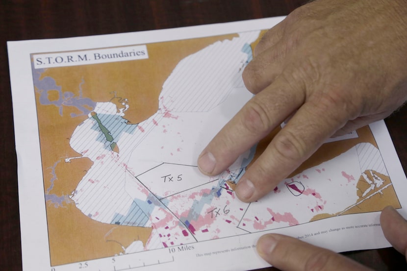 Oyster fisherman Tracy Woody points out some of the areas of existing oyster beds and the...