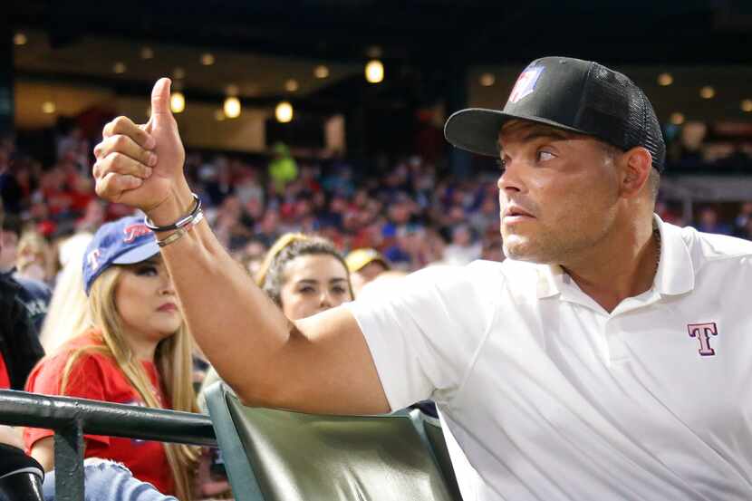 Hall of Fame catcher Ivan "Pudge" Rodriguez gestures to fans during the Los Angeles Angels...