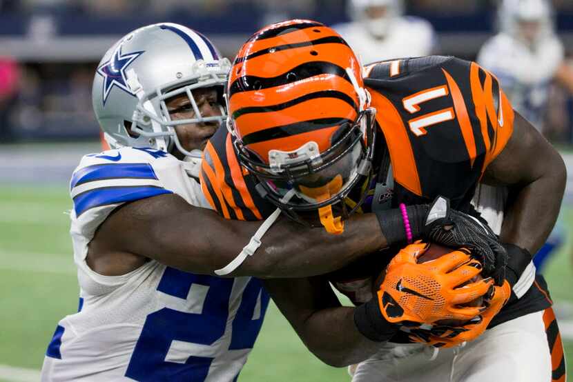 Dallas Cowboys cornerback Morris Claiborne (24) tackles Cincinnati Bengals wide receiver...
