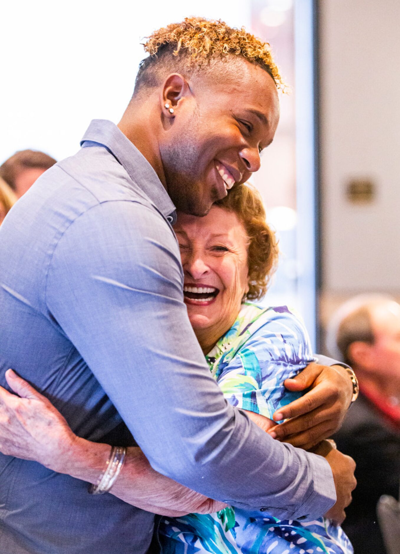 Season ticket holder Shirley Kost hugs former Texas Rangers pitcher Neftalâ Feliz during...