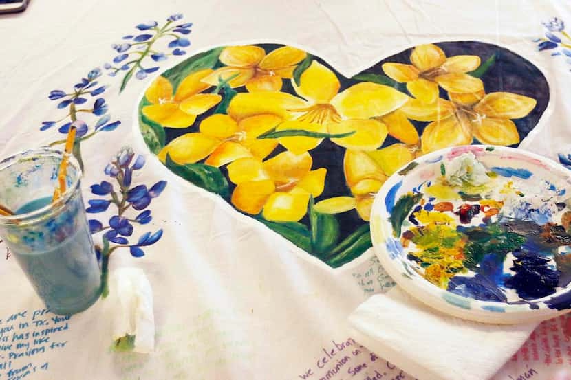 
The Catalyst Arts Movement paints a heart enclosed with nine flowers to honor the nine...