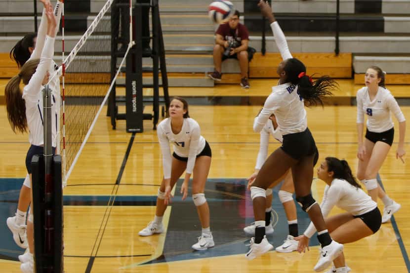 Hebron senior Adanna Rollins (1) skies to score from a spike during the opening game against...