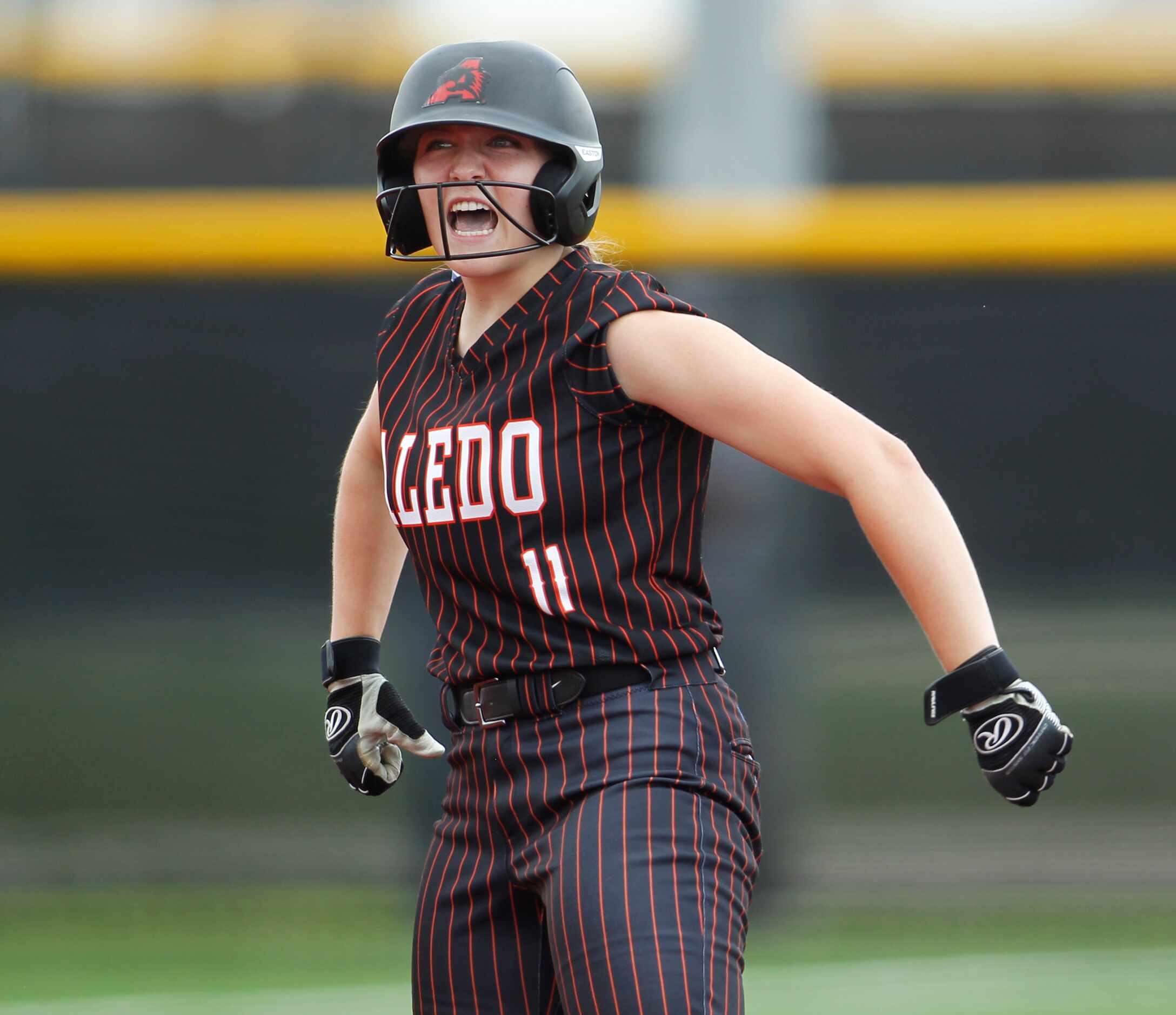 Aledo outfielder Marissa Powell (11) lets out a yell after reaching second base on a double...