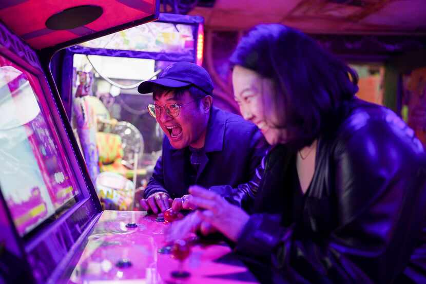 Two people enjoy an arcade game at Meow Wolf Grapevine.