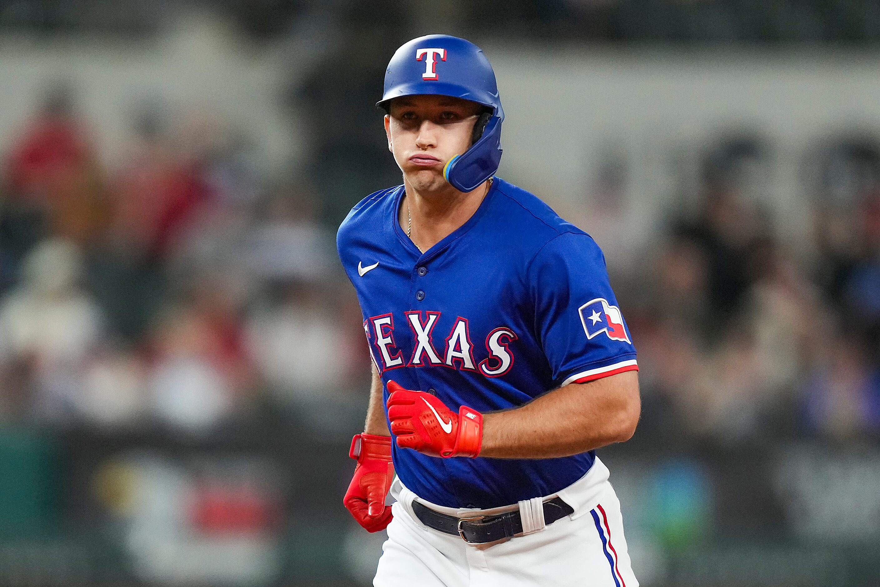 Texas Rangers designated hitter Wyatt Langford reacts after he flew out to left during the...