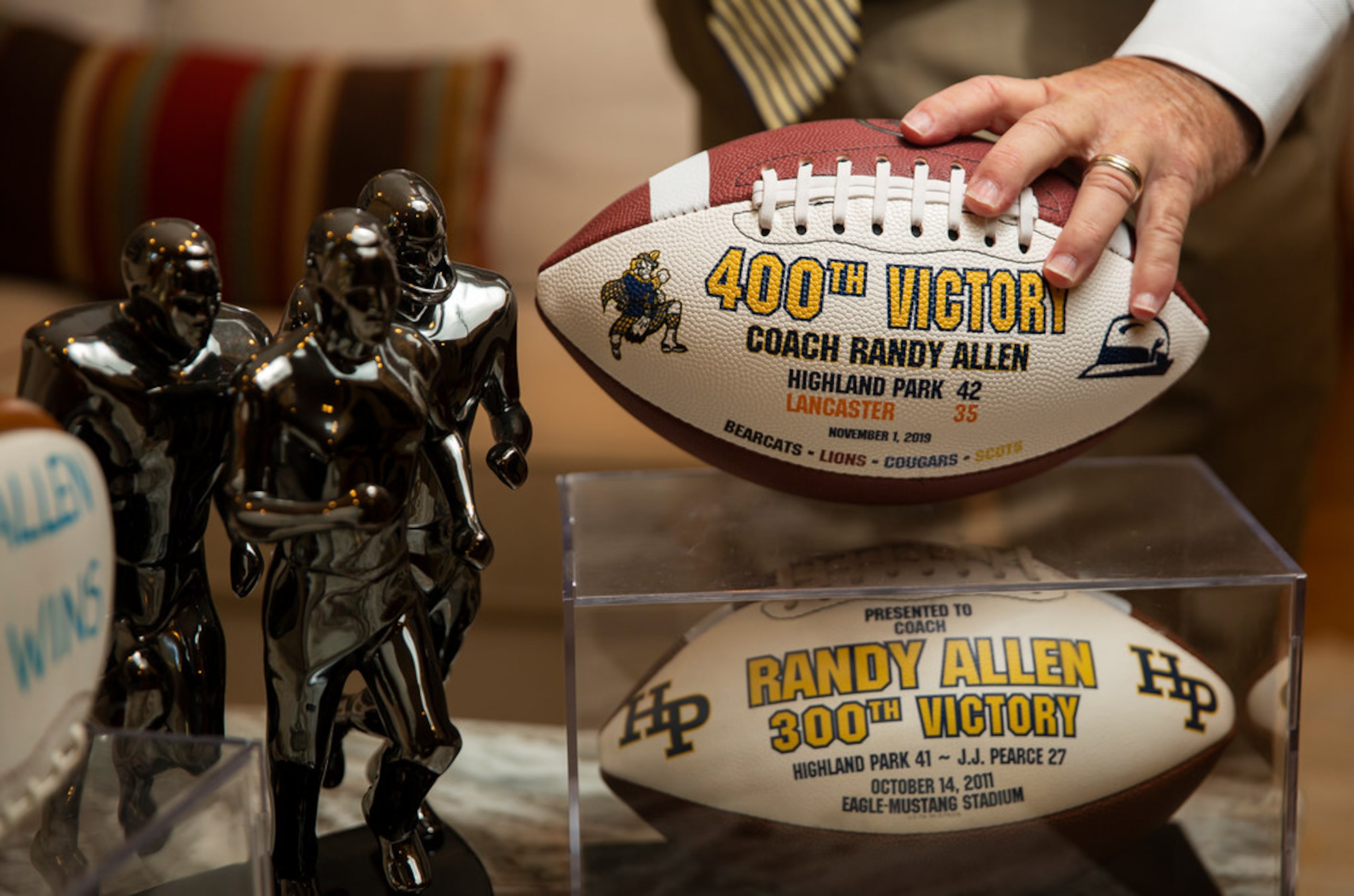 Highland Park football coach Randy Allen adjusts his 400th career victory ball in his...