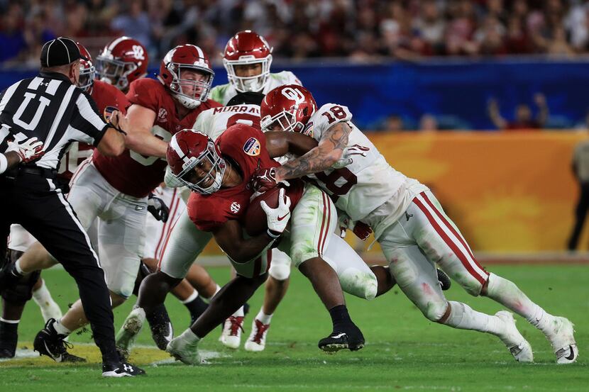MIAMI, FL - DECEMBER 29: Curtis Bolton #18 of the Oklahoma Sooners makes the tackle on Josh...