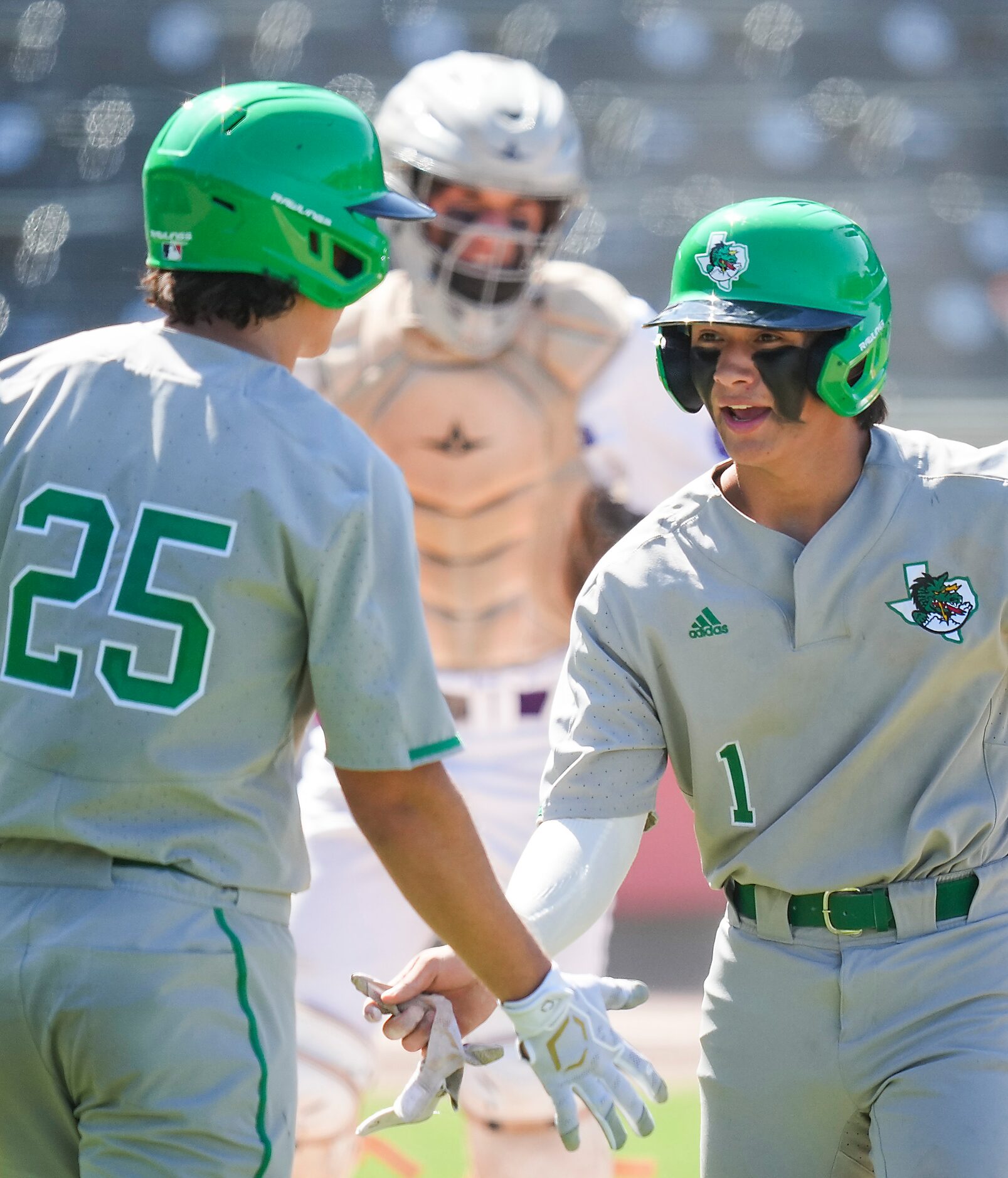 Southlake Carroll shortstop Ethan Mendoza (1) celebrates with first baseman Nick Jones (25)...