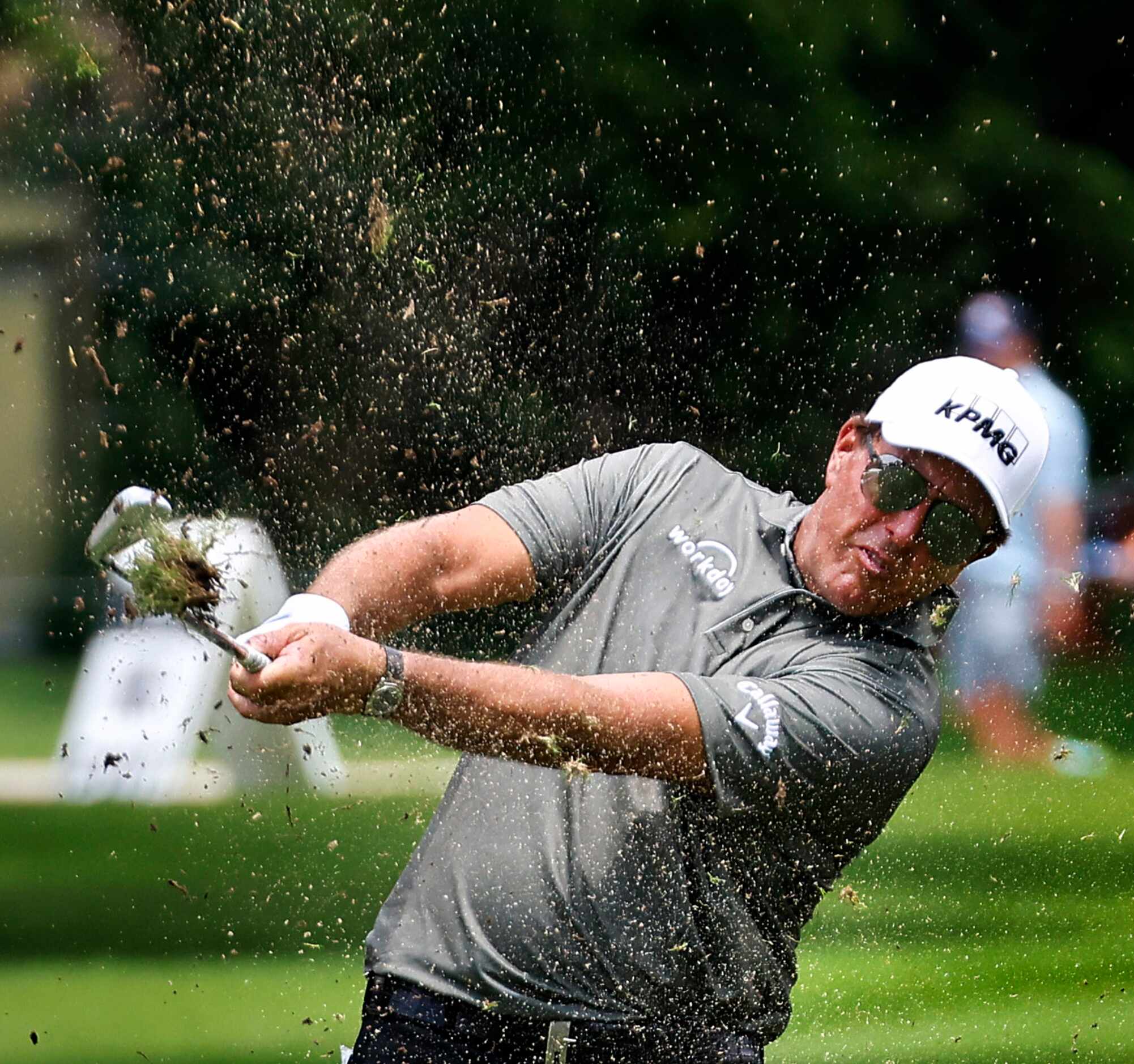 Professional golfer Phil Mickelson follows through  on his approach shot on No. 9 during...