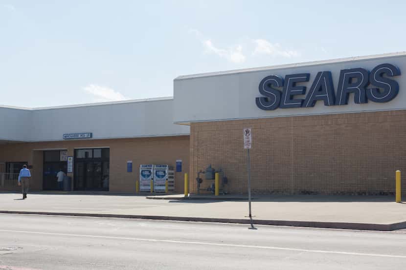 Customers walk into Sears at Golden Triangle Mall.  Localizing corporate concern Sears has...