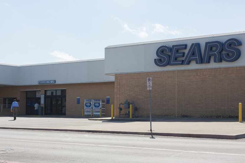 Customers walk into Sears at Golden Triangle Mall.  Localizing corporate concern Sears has...