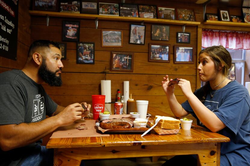 Pete and Dakota Rodriguez of Houston react after taking their first bite of a rib at Snow's...