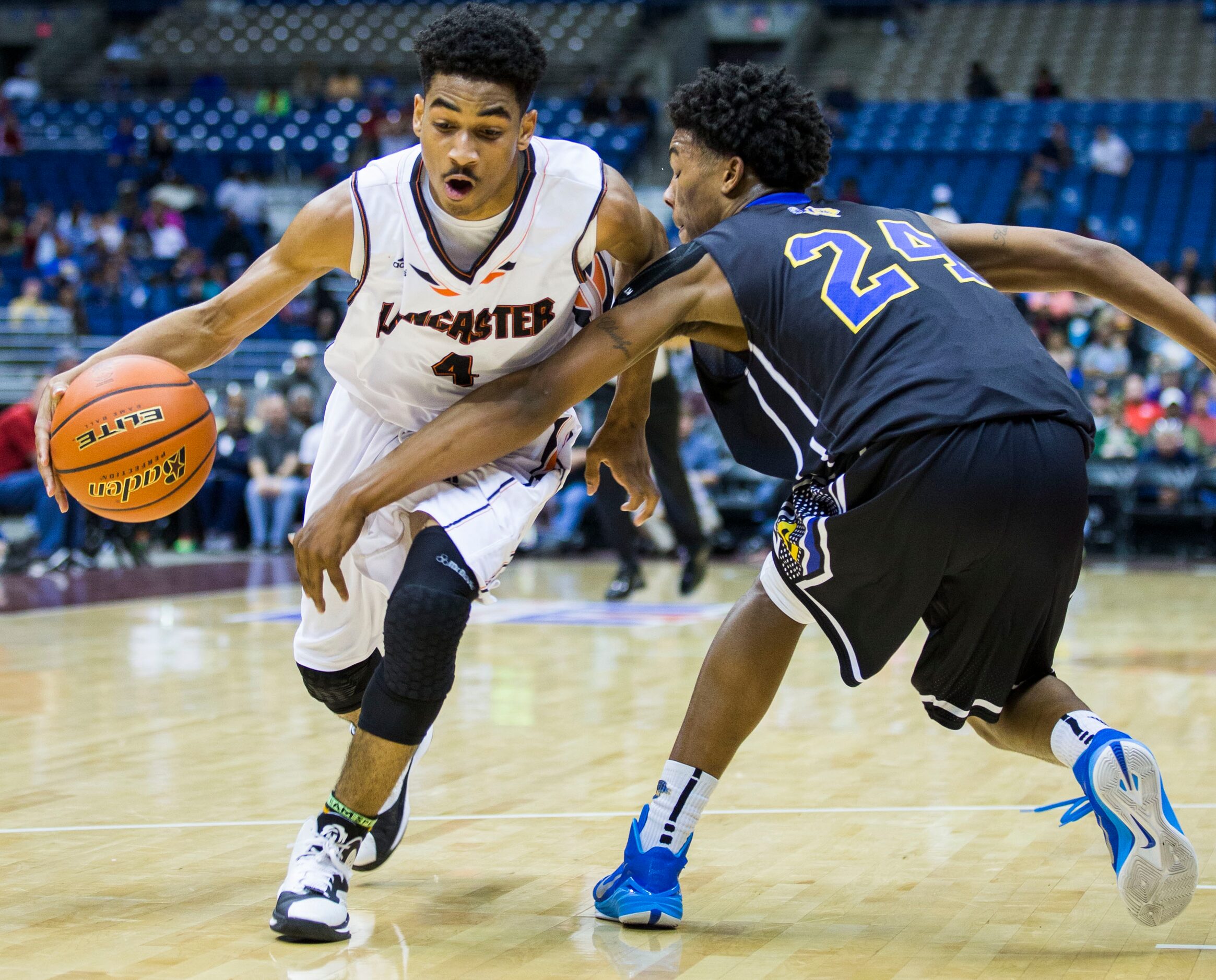 Lancaster guard Ike Durham (4) is defended by Beaumont Ozen forward Christian Bolton (24)...