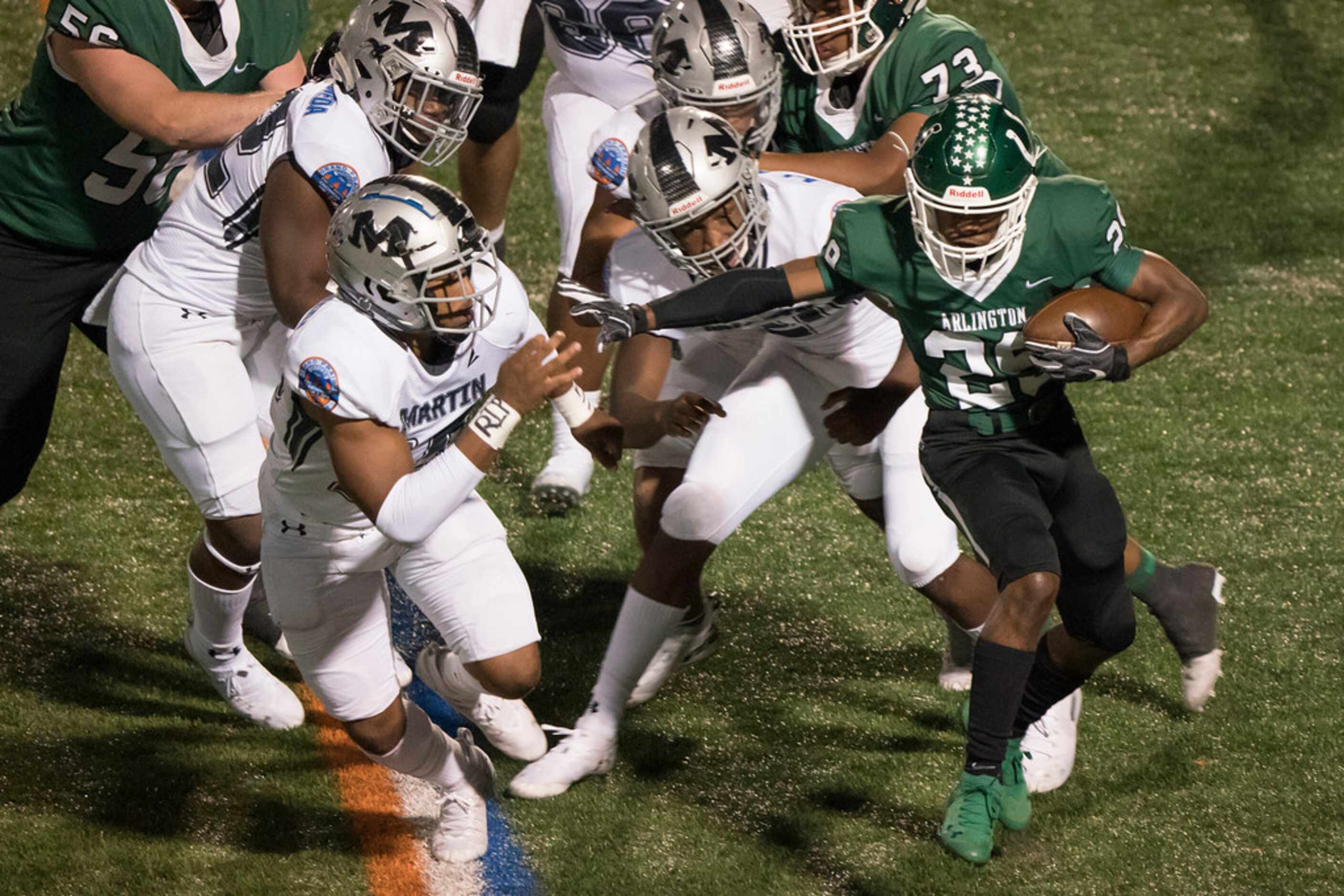 Arlingtong running back  Zander Benson (29) is chased down by the Arlington Martin defense,...