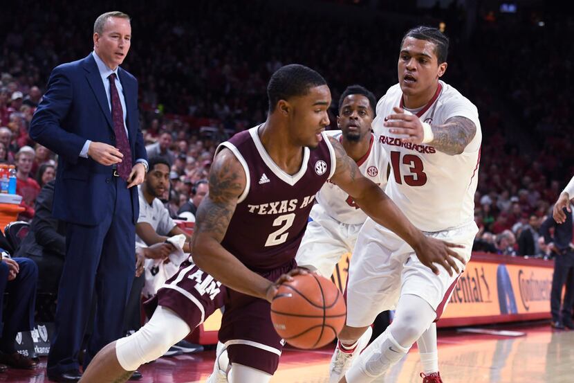 Texas A&M guard TJ Starks tries to get past Arkansas defender Dustin Thomas during the first...
