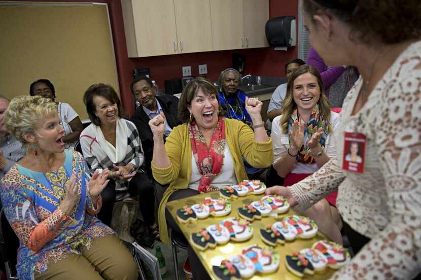 Suzy Cravens (center) reacts as she is announced winner of the "Cookie Man" category during...