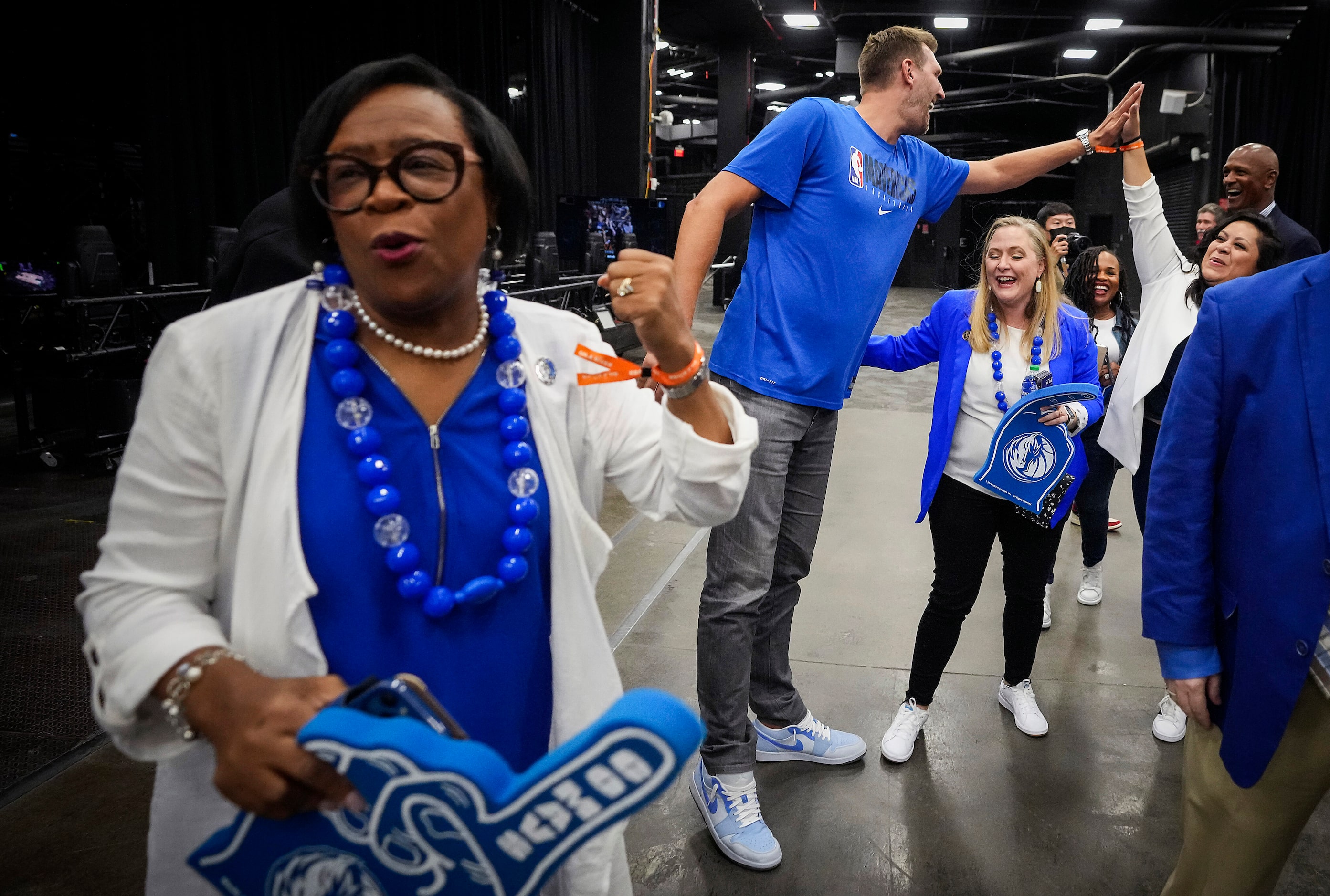 Dallas Mavericks great Dirk Nowitzki celebrates with team staff, including CEO Cynt Marshall...