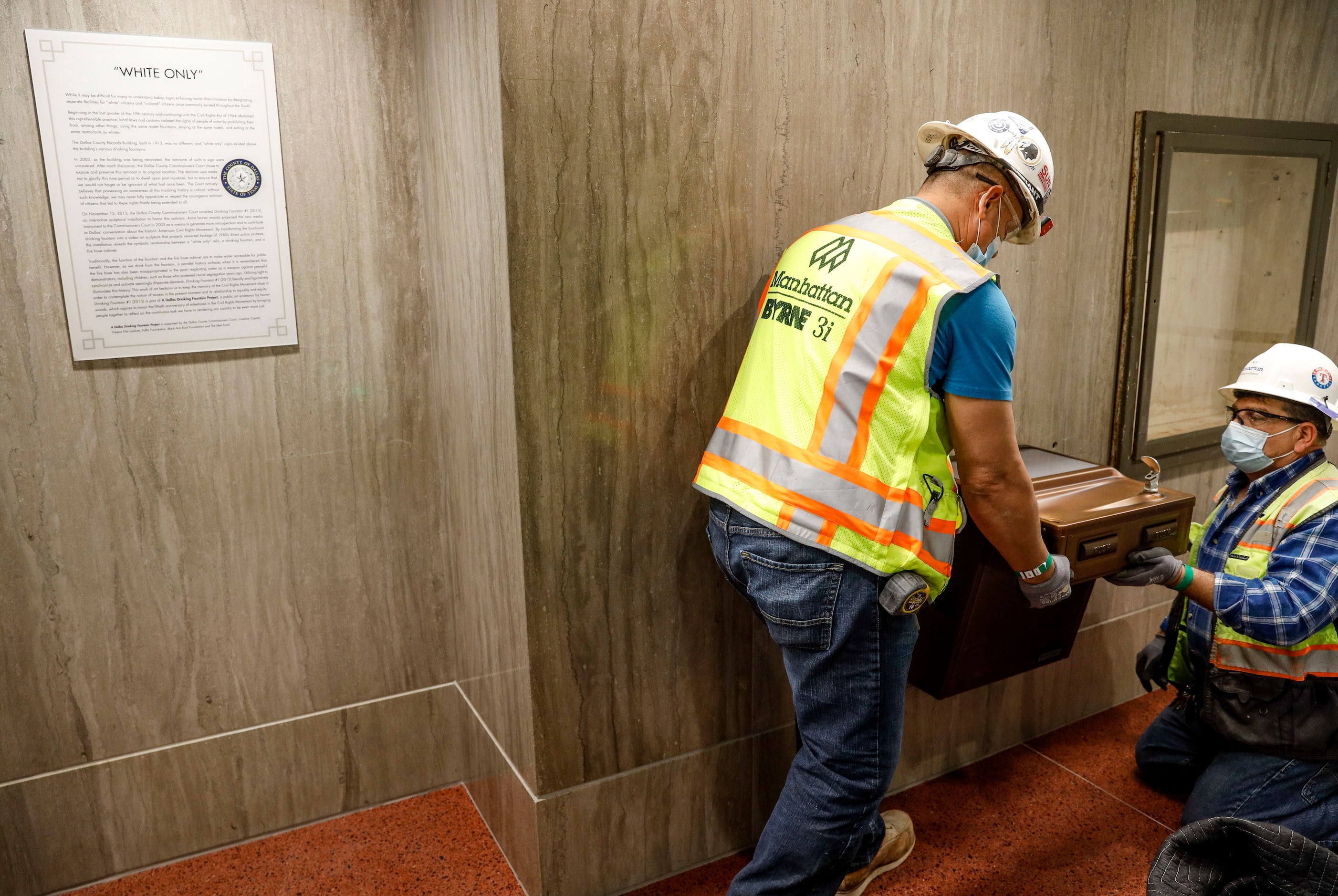 Saul Fuentes and Mario Vilatoro fit a segregation-era water fountain before it is sent for...