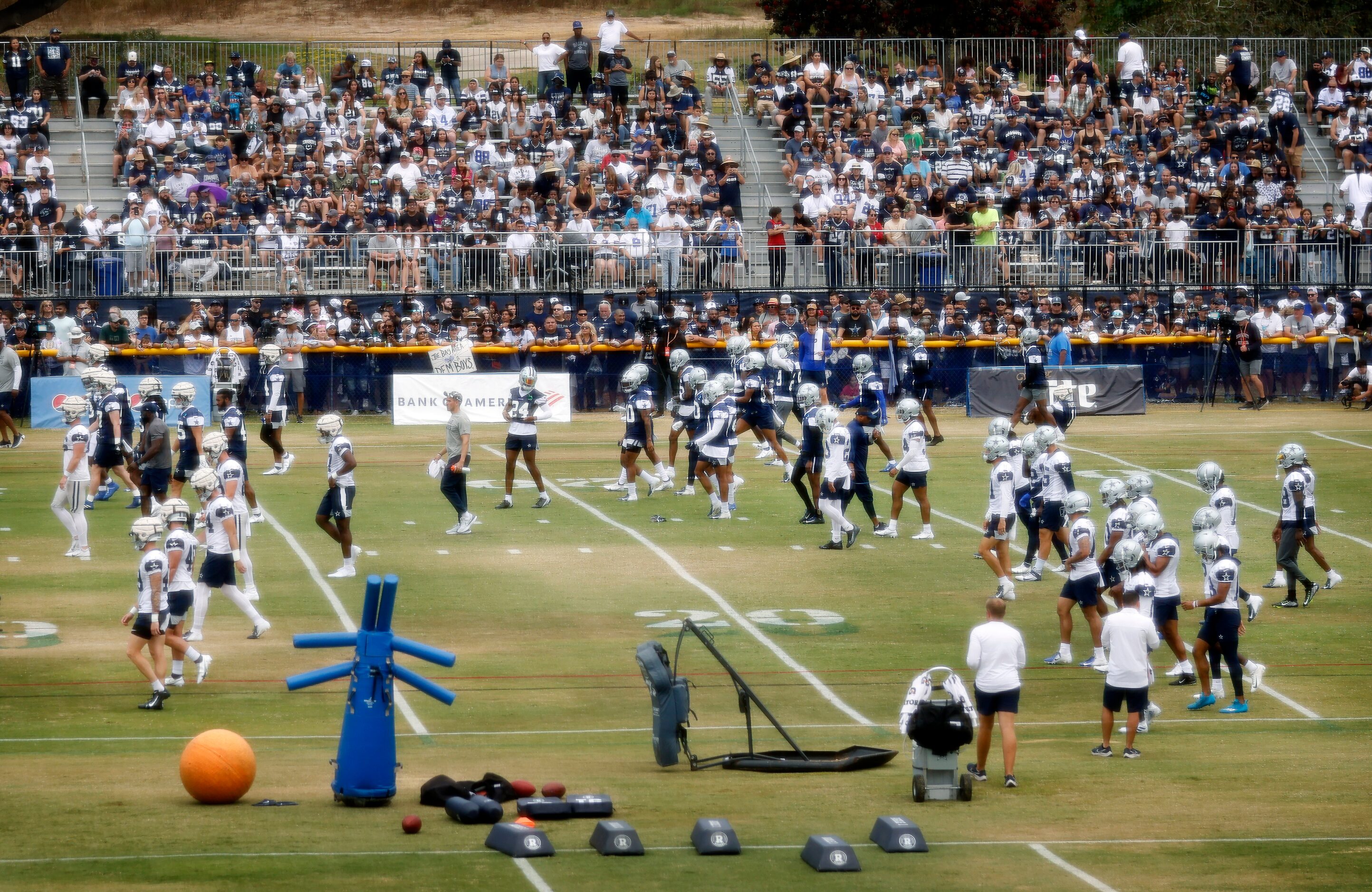 The Dallas Cowboys football team trains before over 4,000 fans at the Cowboys training camp...